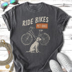 Dark t-shirt with distressed graphic of a bicycle and dog, text "RIDE BIKES PET DOGS".
