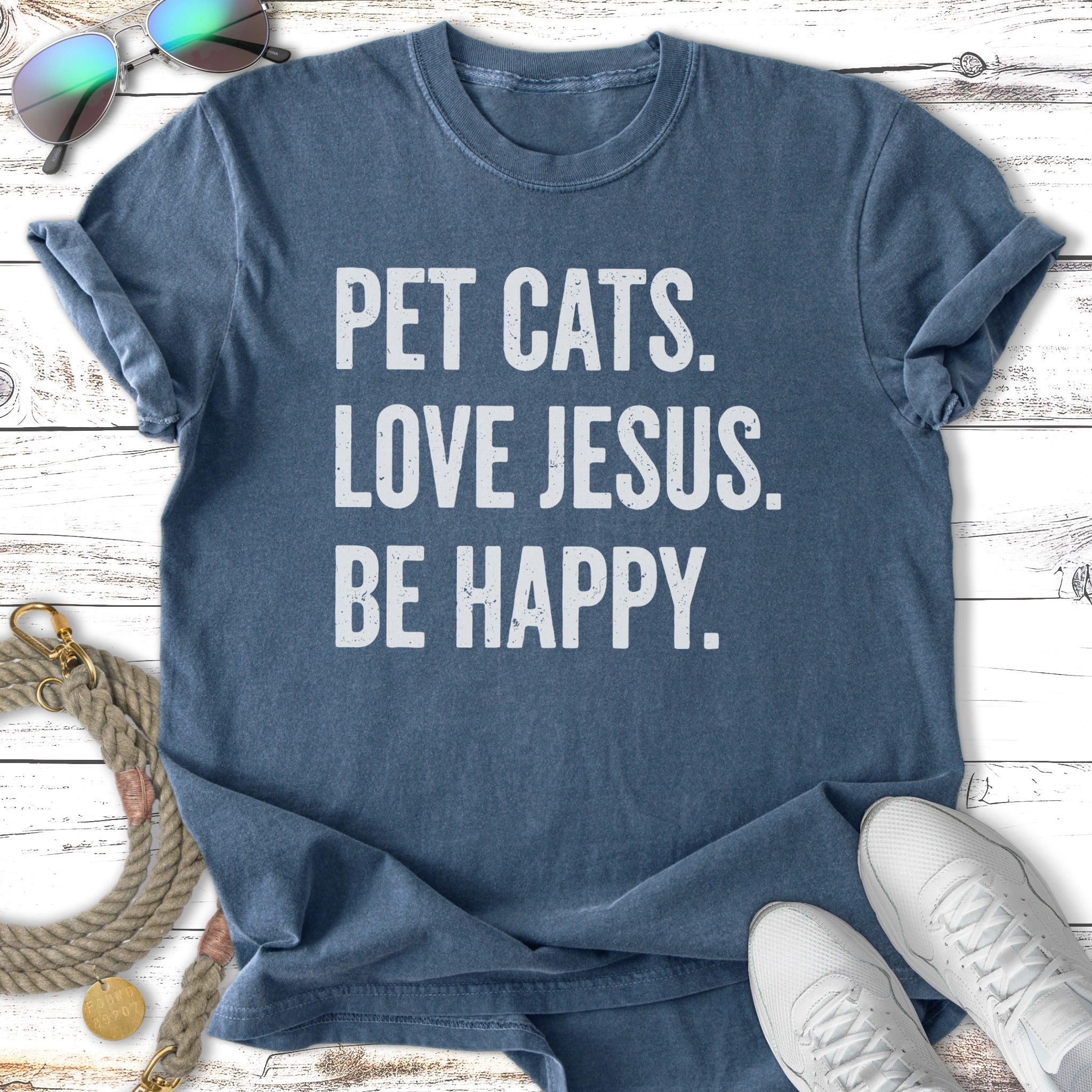 Blue t-shirt with white text reading "PET CATS. LOVE JESUS. BE HAPPY."