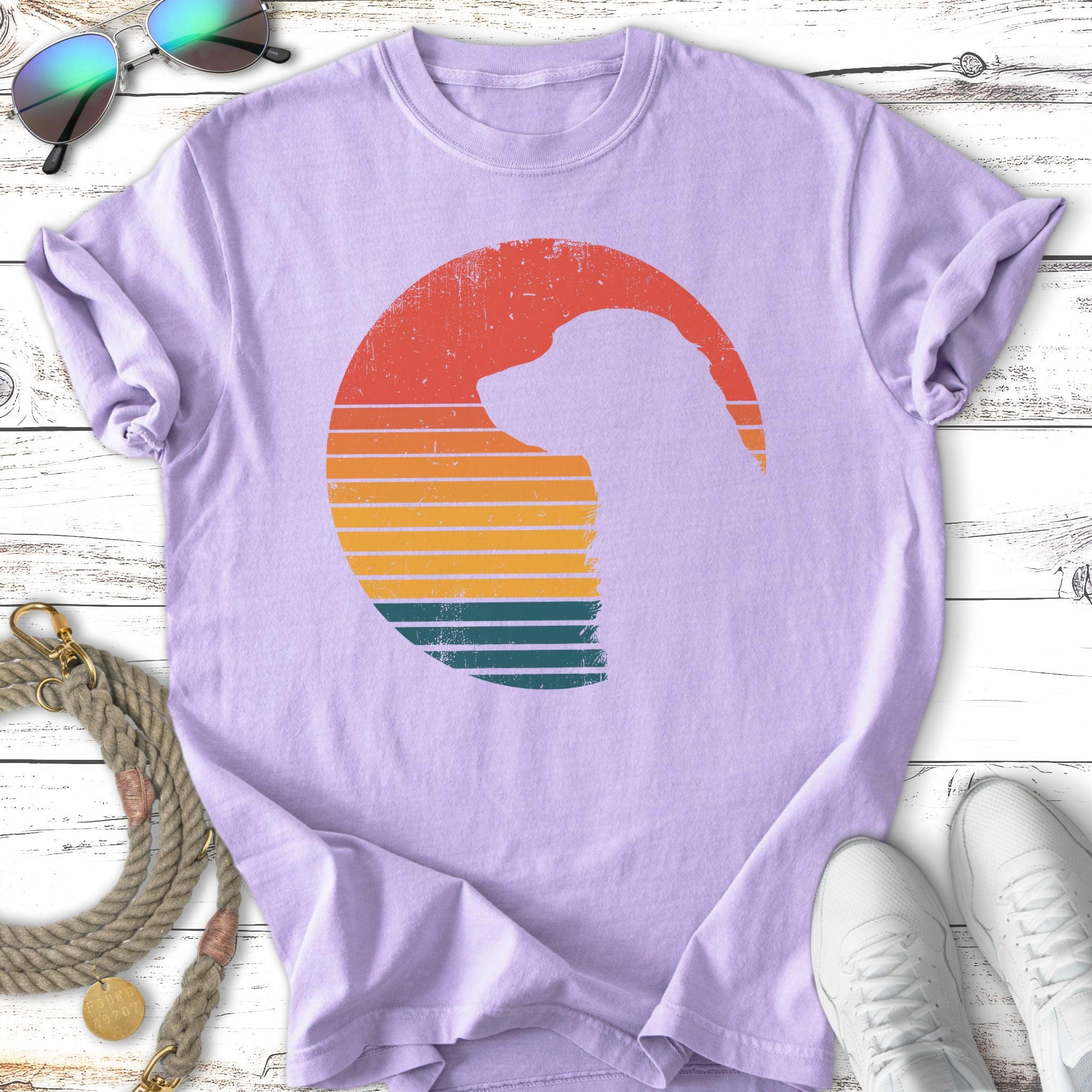 Lavender t-shirt with a dog silhouette in a retro sunset circle.