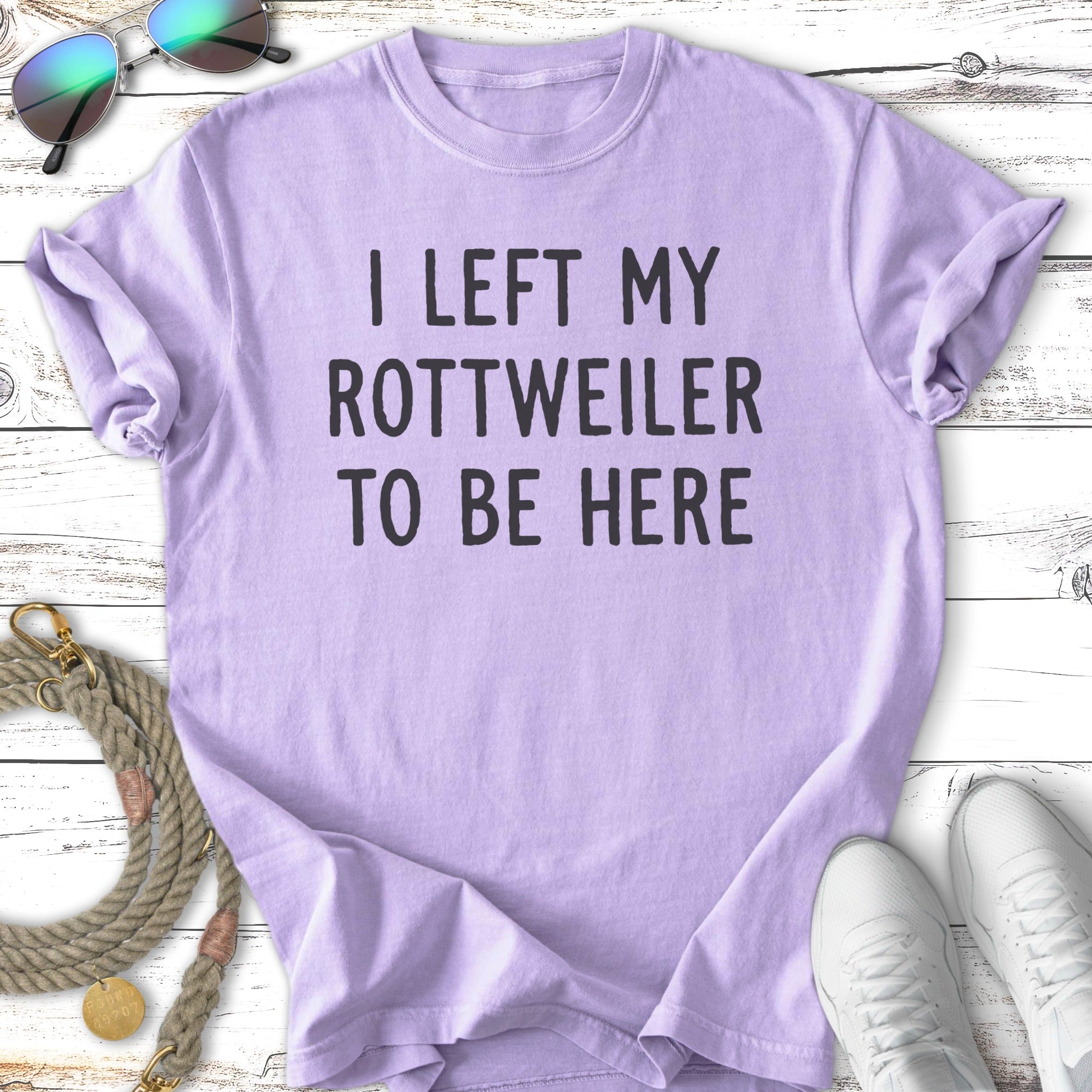 Purple t-shirt with text "I LEFT MY ROTTWEILER TO BE HERE".