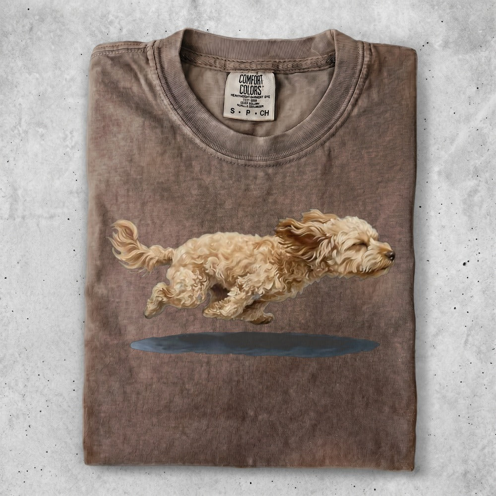 Brown t-shirt with a brown and white dog running across a blue puddle.