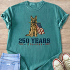 German Shepherd holding American flag with "250 YEARS 1776-2026" text.