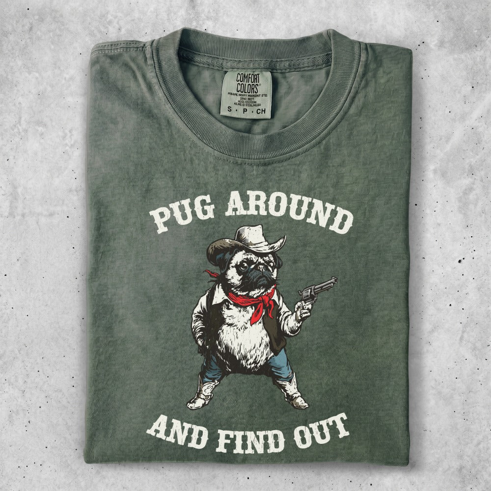 Green t-shirt with pug wearing a bandana and holding a pistol.