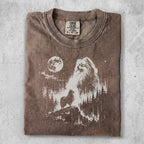 Brown t-shirt with distressed graphic of a wolf on a mountain with moon and trees.