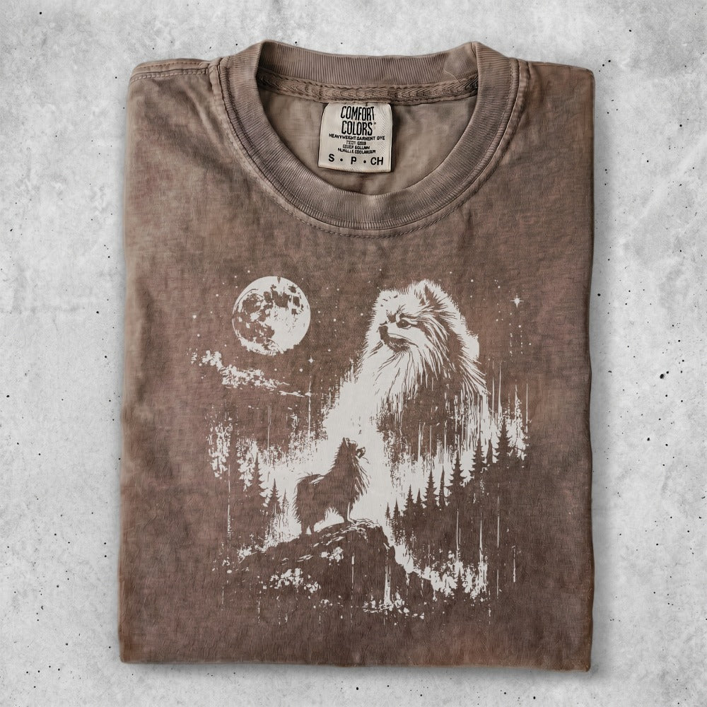 Brown t-shirt with distressed graphic of a wolf on a mountain with moon and trees.