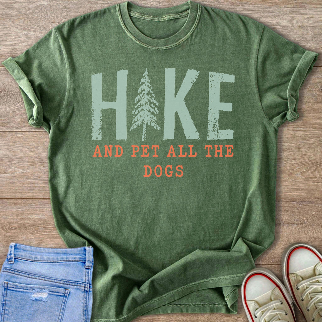 Green t-shirt with "HIKE AND PET ALL THE DOGS" text and a tree graphic.