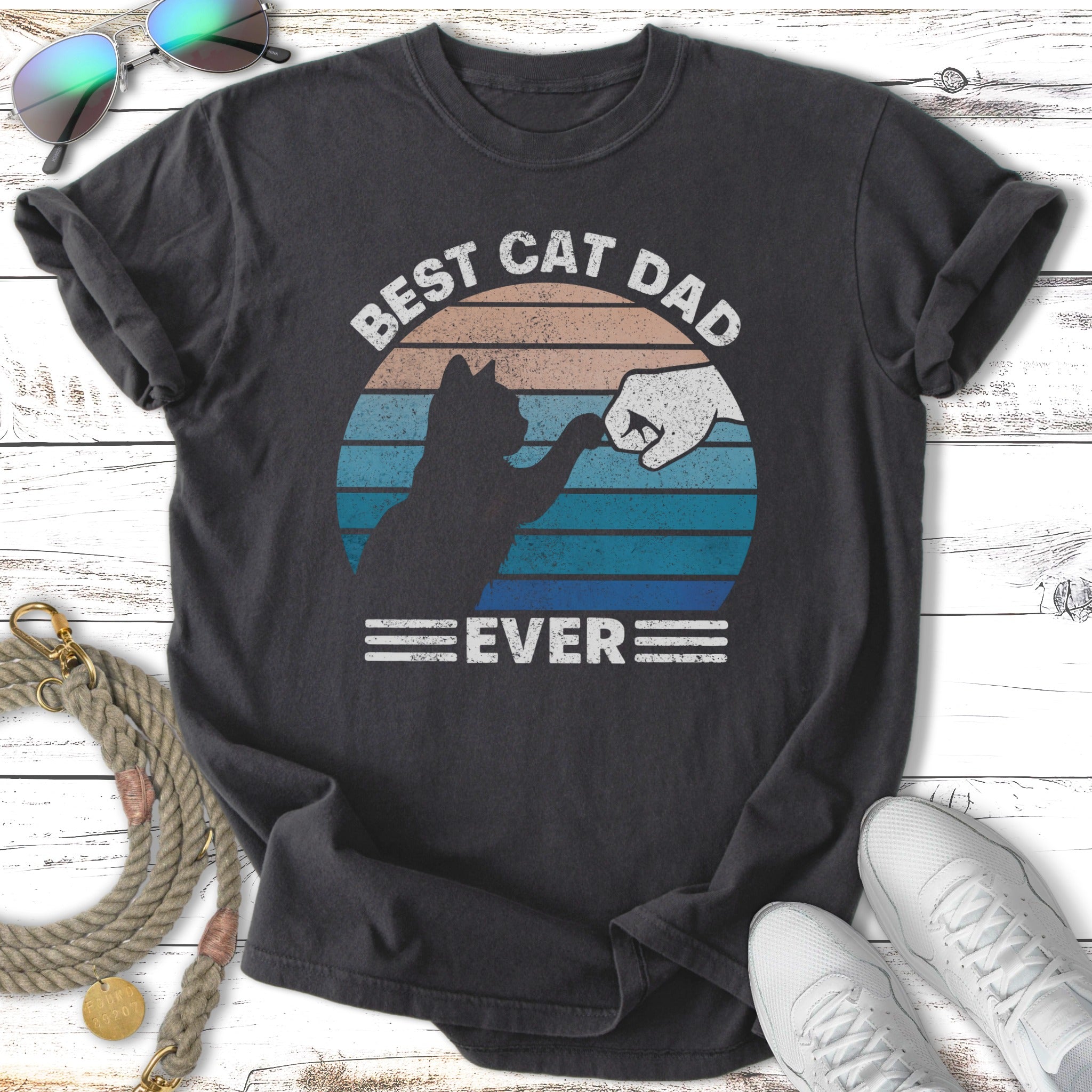 Dark t-shirt with "BEST CAT DAD EVER" and fist bump graphic.