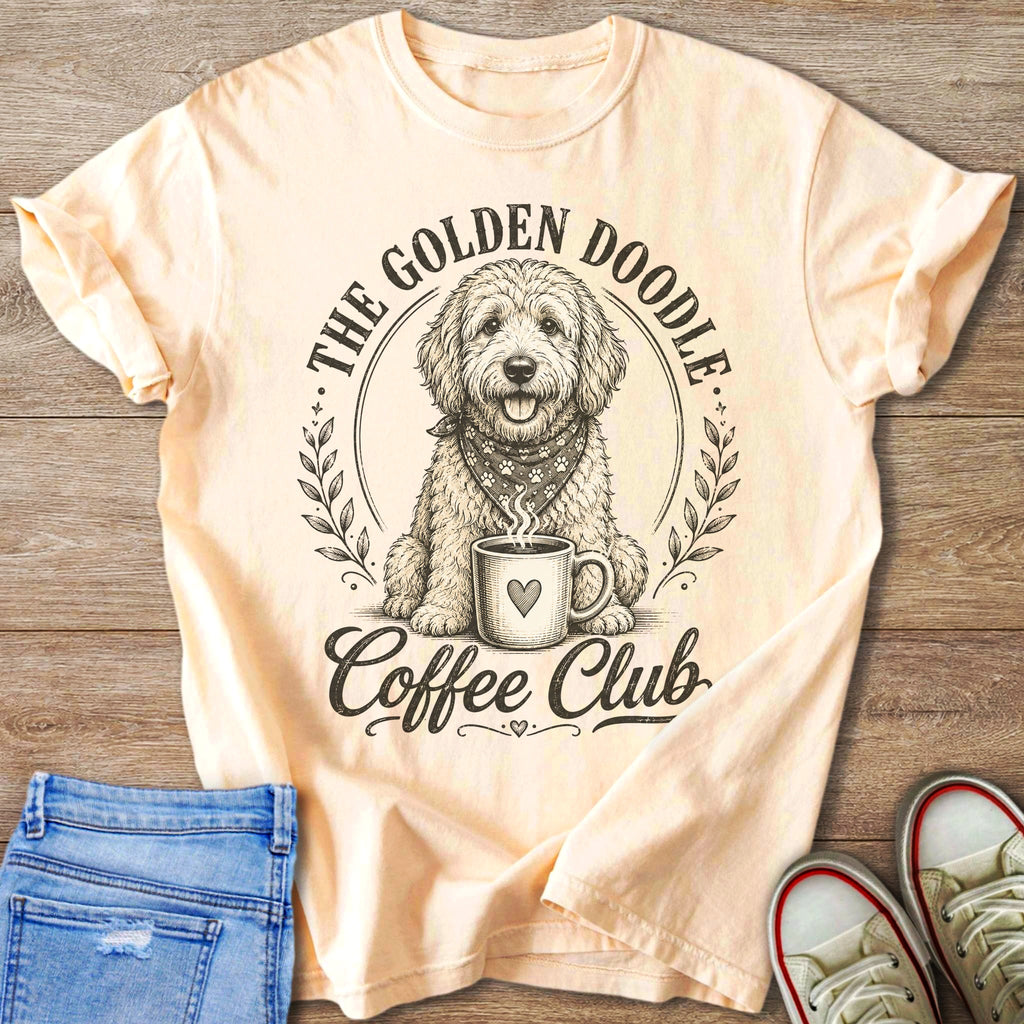Peach t-shirt with a doodle dog, coffee cup, and text "The Golden Doodle Coffee Club".