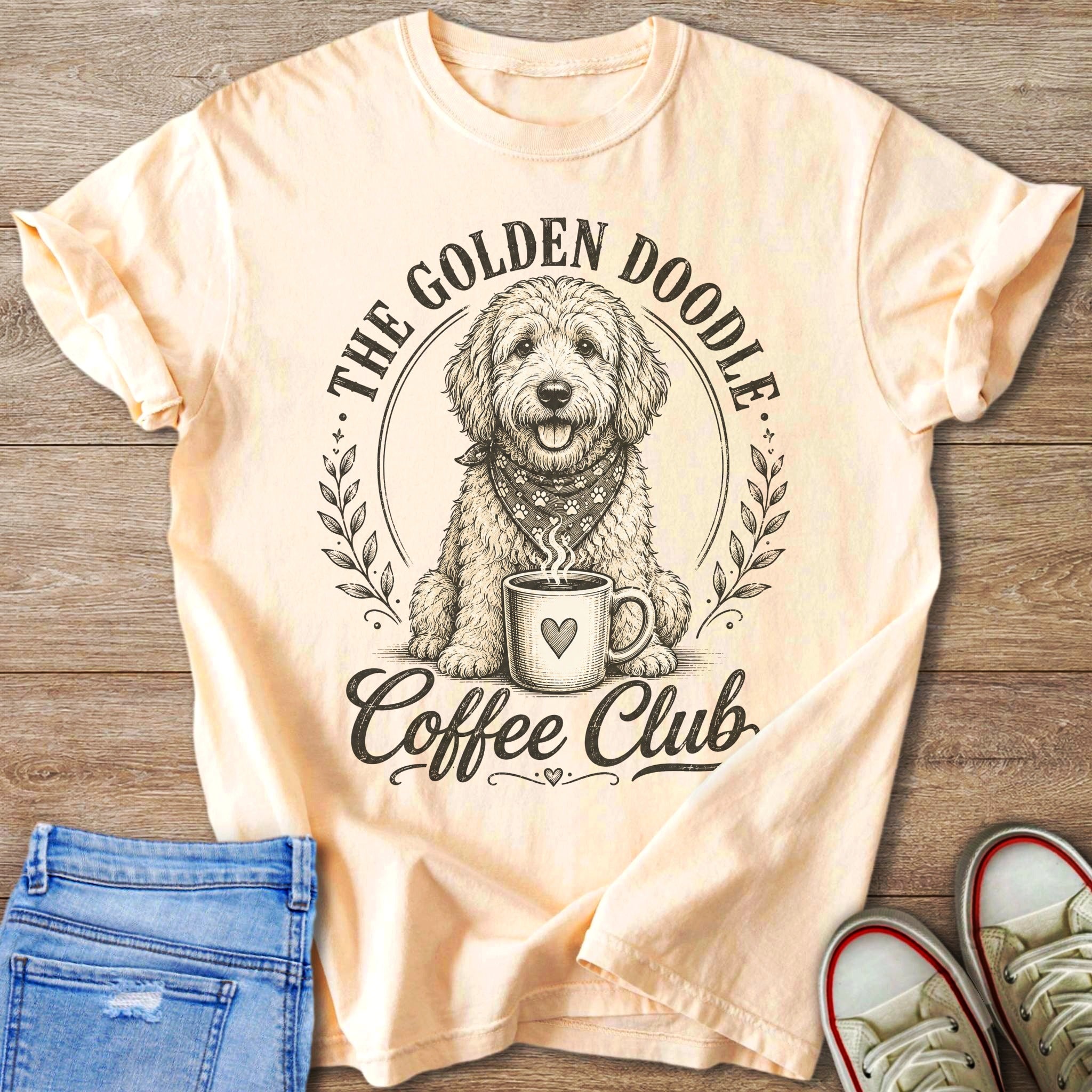 Peach t-shirt with a doodle dog, coffee cup, and text "The Golden Doodle Coffee Club".