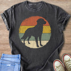 Dark t-shirt with a black dog silhouette on a retro striped circle design.