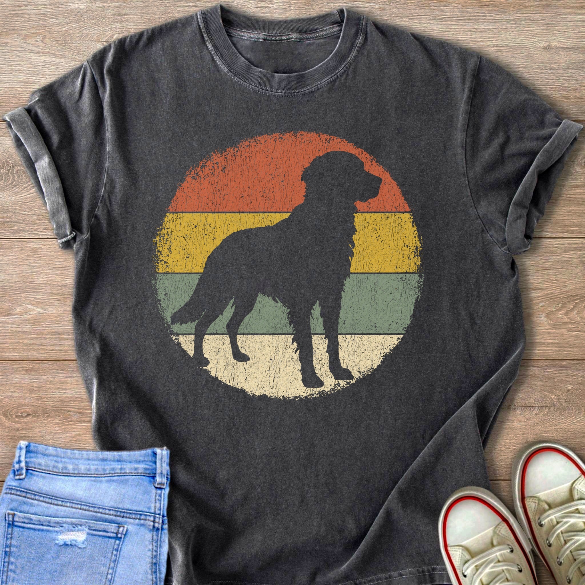 Dark t-shirt with a black dog silhouette on a retro striped circle design.