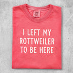 Red t-shirt with "I LEFT MY ROTTWEILER TO BE HERE" text.