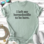 Light green t-shirt with "I left my Bernedoodle to be here."