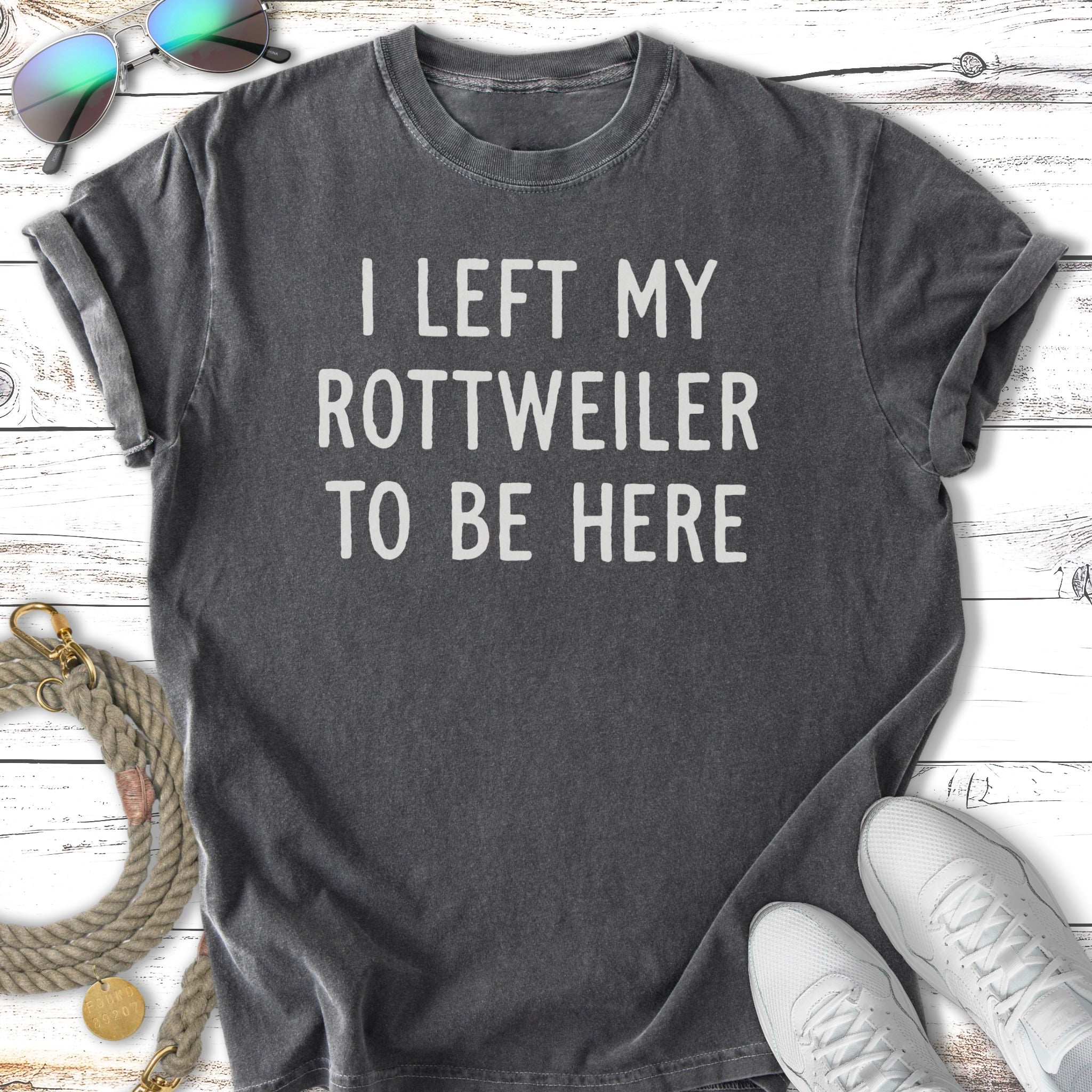 Dark grey t-shirt with white text reading "I LEFT MY ROTTWEILER TO BE HERE".