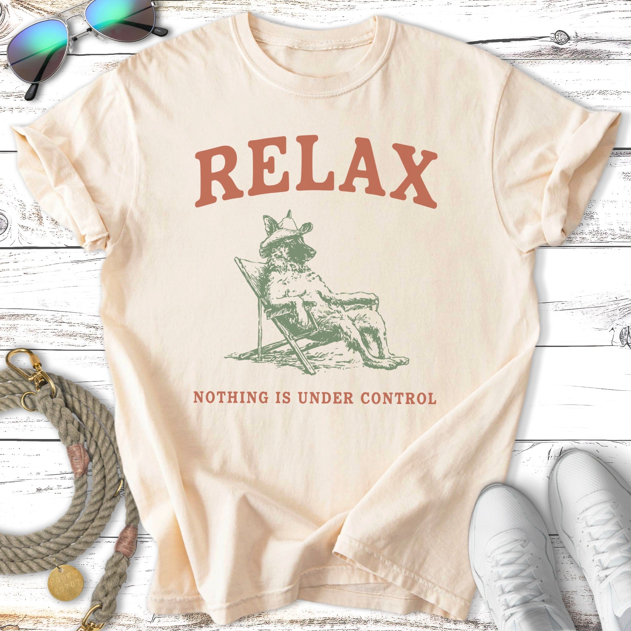 Cream t-shirt with "RELAX NOTHING IS UNDER CONTROL" and a dog in a lounge chair.