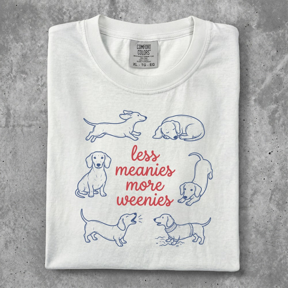 White t-shirt with dachshund illustrations and "less meanies, more weenies" text.