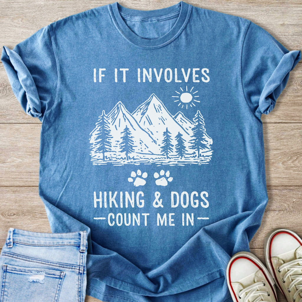 "If it involves hiking & dogs – count me in" graphic t-shirt with mountain and tree illustration.