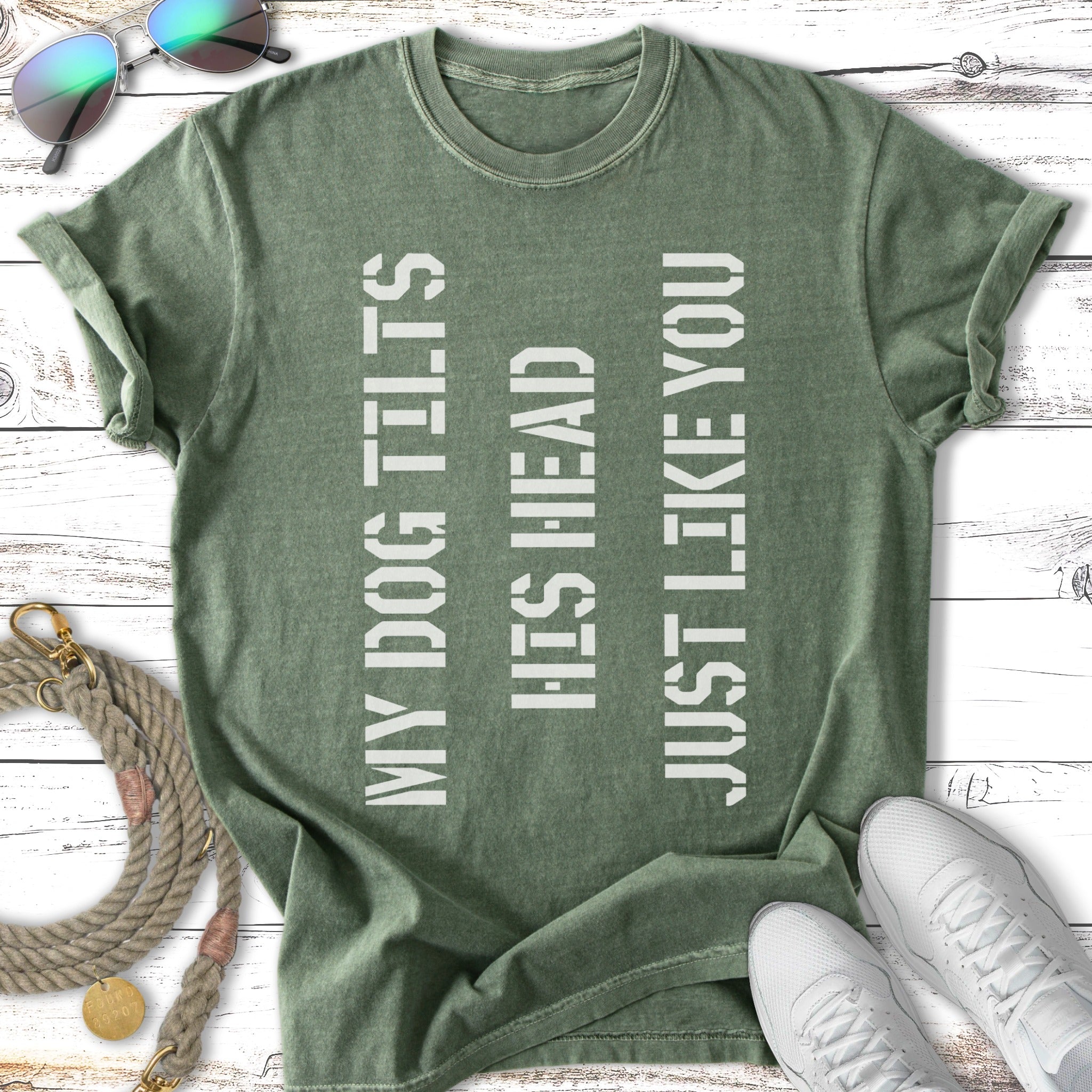 Green t-shirt with "MY DOG TILTS HIS HEAD JUST LIKE YOU" text.