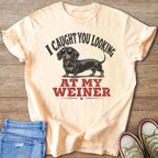 Peach t-shirt with dachshund wearing sunglasses and text "I CAUGHT YOU LOOKING AT MY WEINER".