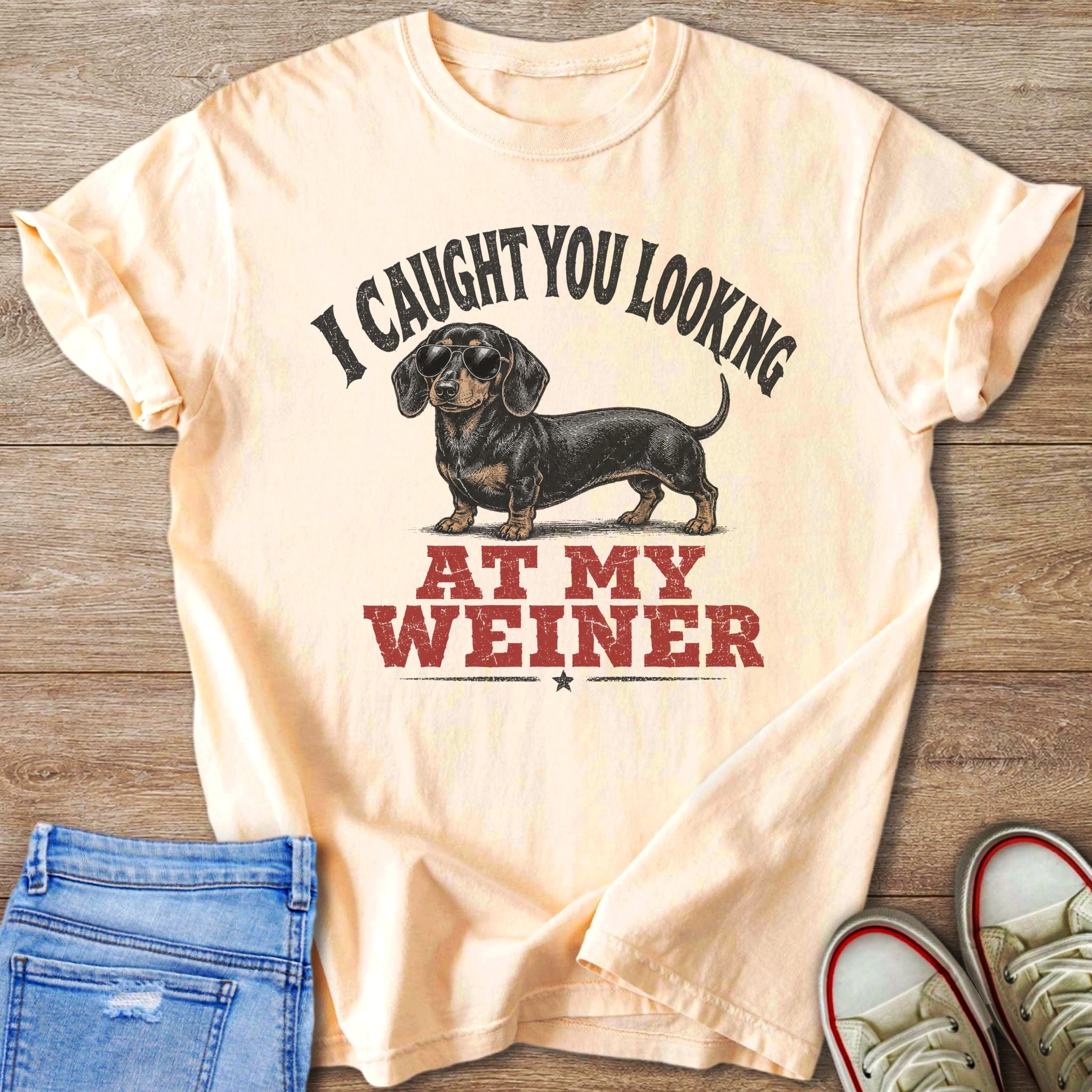 Peach t-shirt with dachshund wearing sunglasses and text "I CAUGHT YOU LOOKING AT MY WEINER".