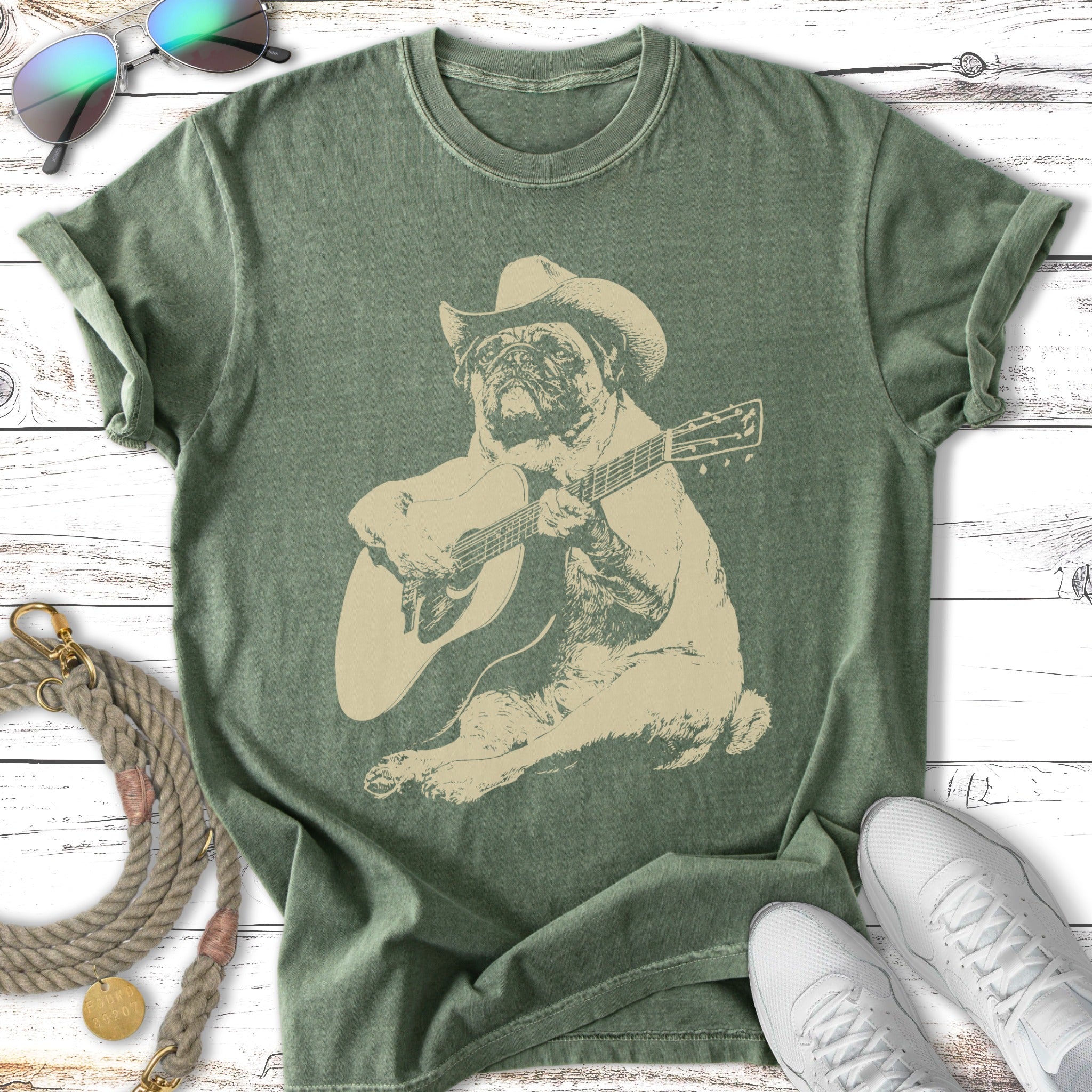 Pug wearing a cowboy hat plays an acoustic guitar.