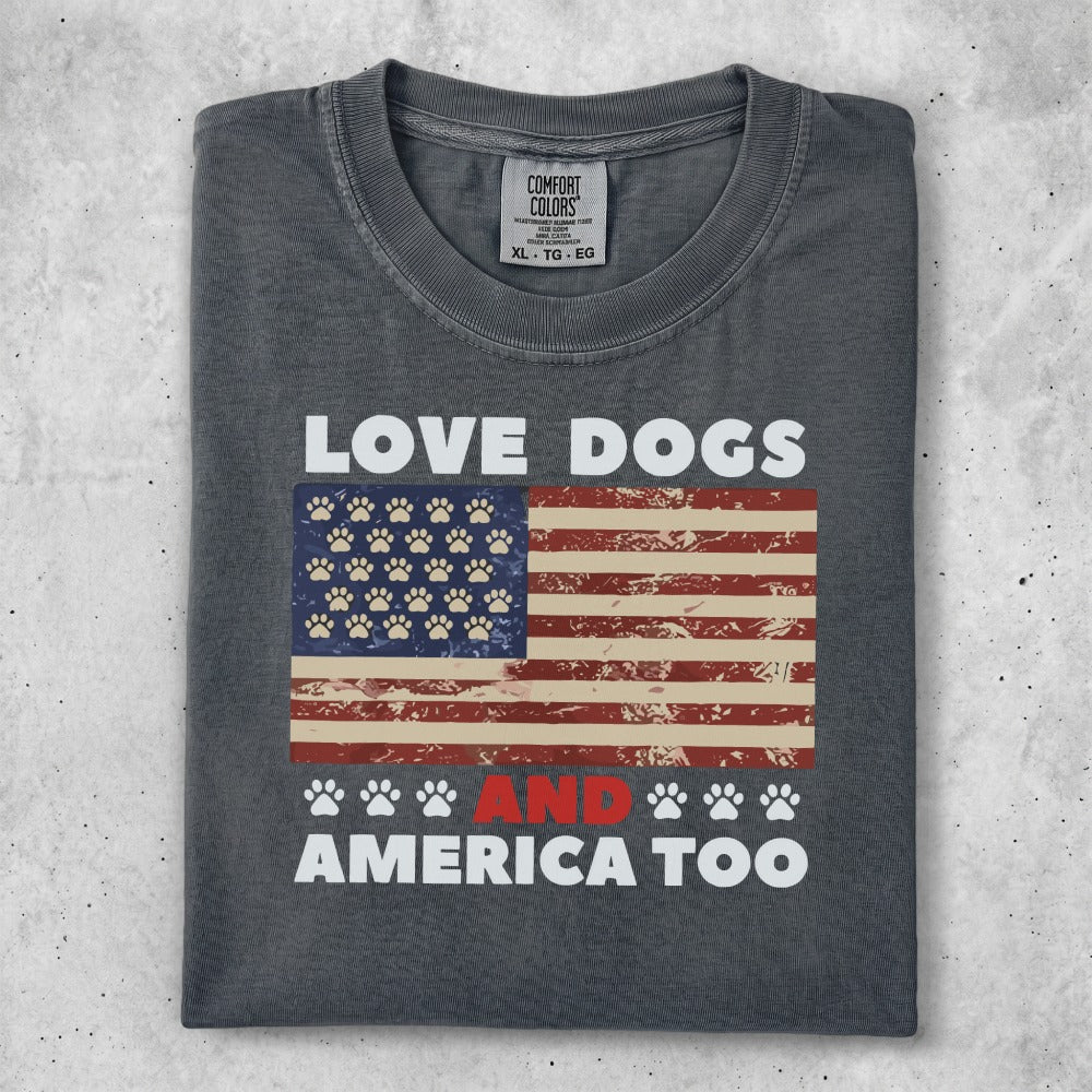 Dark gray t-shirt with "LOVE DOGS AND AMERICA TOO" text and paw print flag.