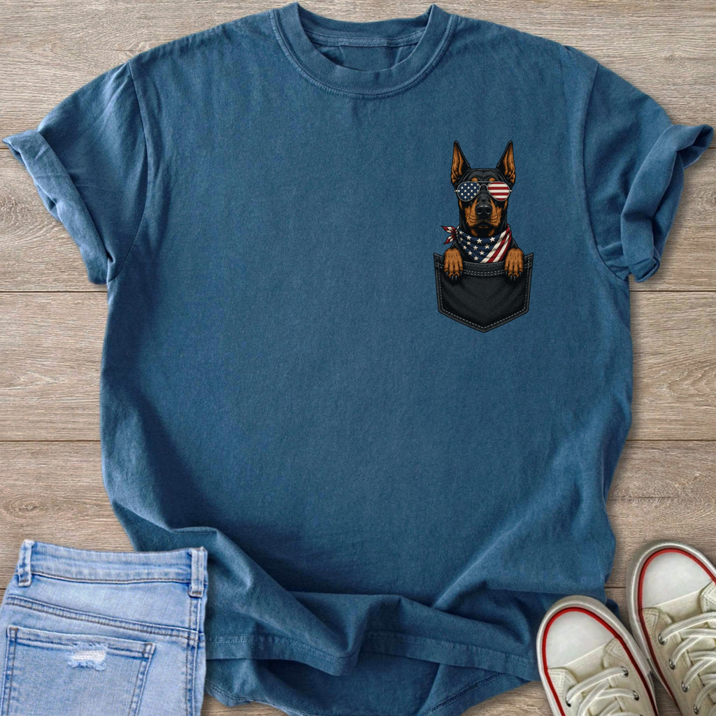 Blue t-shirt with a graphic of a dog wearing American flag sunglasses and bandana in a pocket.