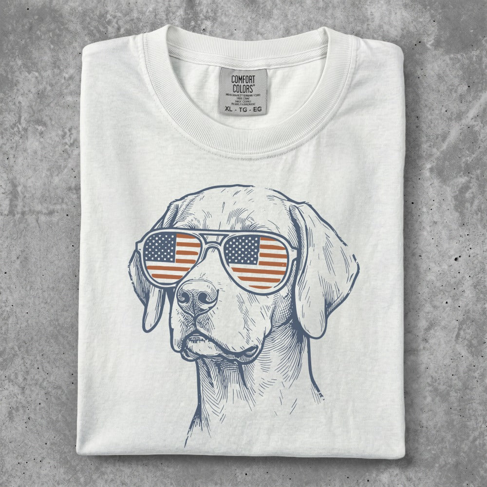 White t-shirt with patriotic dog wearing American flag sunglasses.