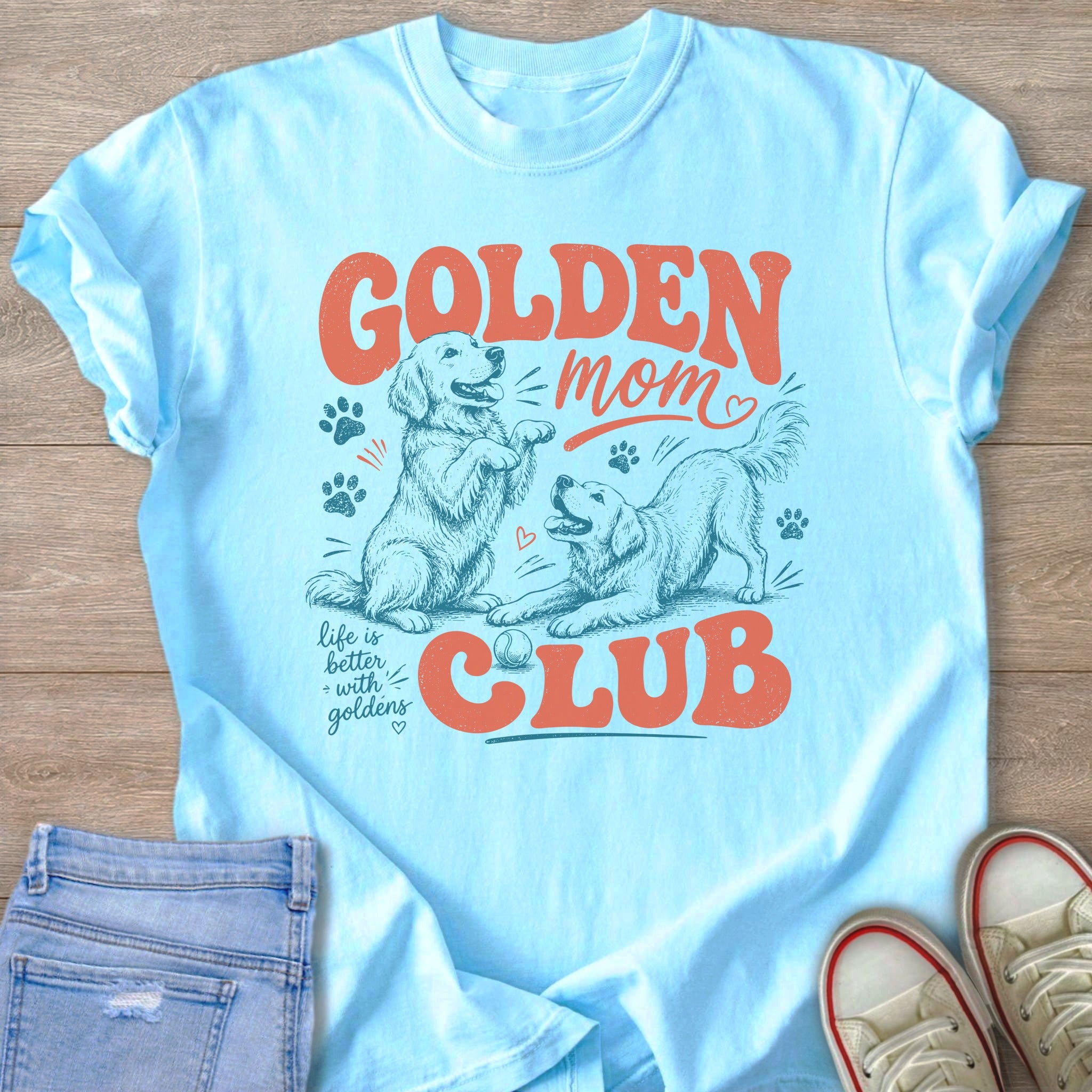 Light blue t-shirt with "Golden Mom Club" text and two golden retrievers playing.