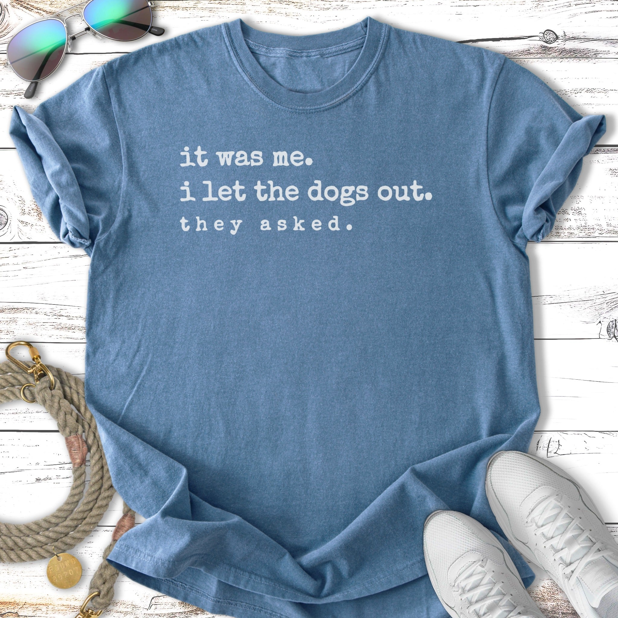 Blue t-shirt with text "it was me. i let the dogs out. they asked."