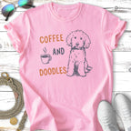 Pink t-shirt with "Coffee and Doodles" text and a doodle dog illustration.