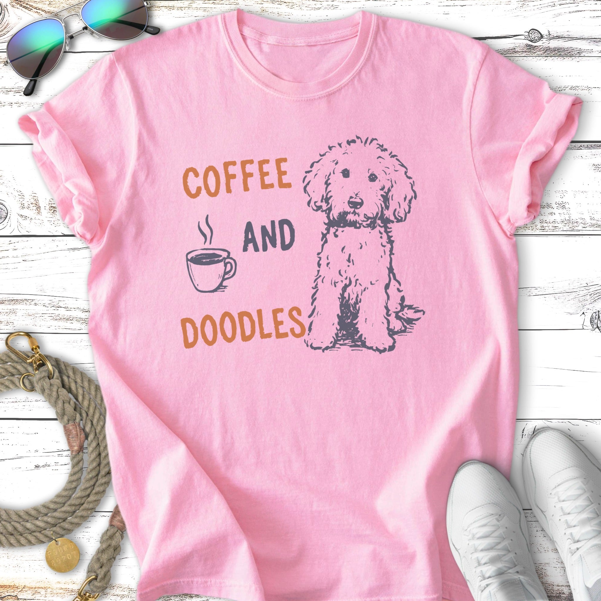 Pink t-shirt with "Coffee and Doodles" text and a doodle dog illustration.