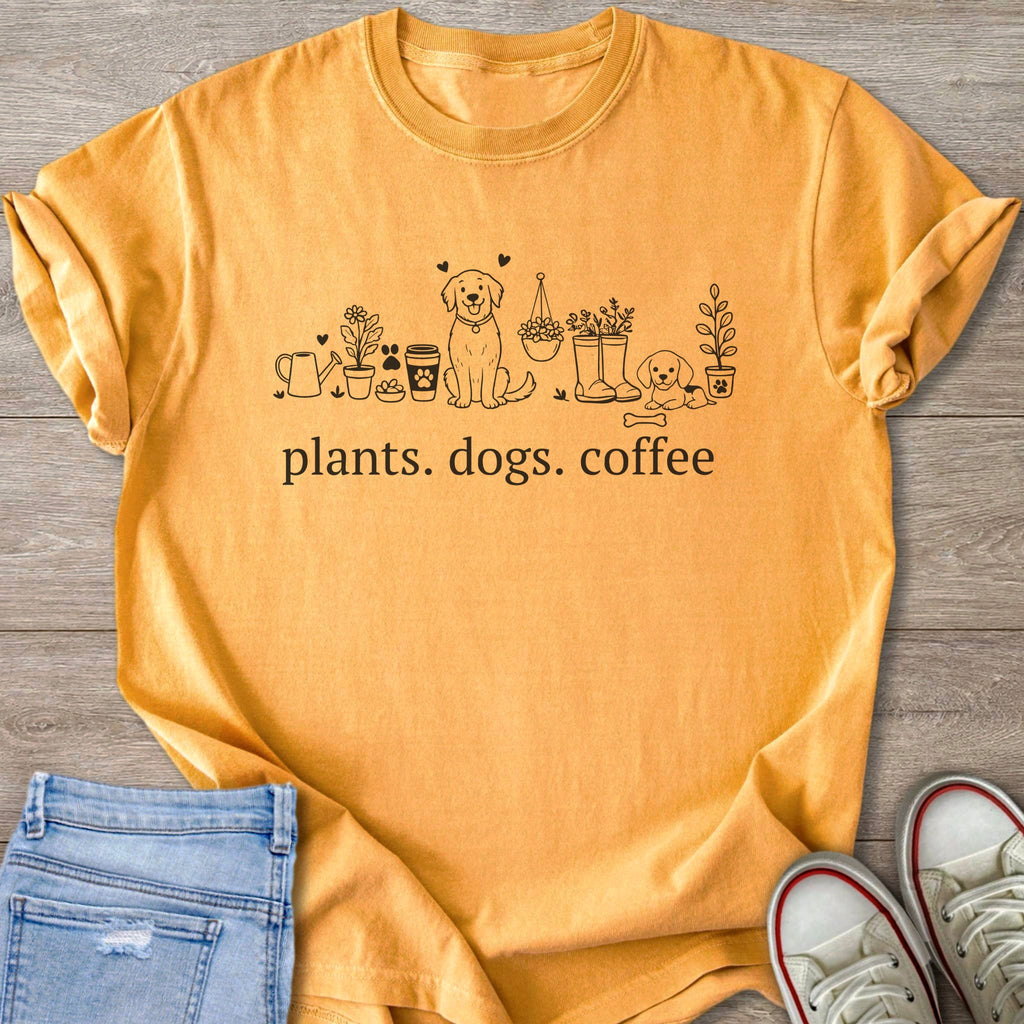 Yellow t-shirt with black line art of plants, dogs, coffee cups, and the words "plants. dogs. coffee."