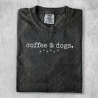Dark gray t-shirt with "coffee & dogs." and paw prints graphic.