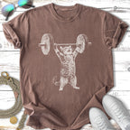 Cat lifting a barbell with weight plates, on a brown t-shirt.