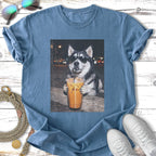 Husky wearing sunglasses drinks iced coffee from a large cup.