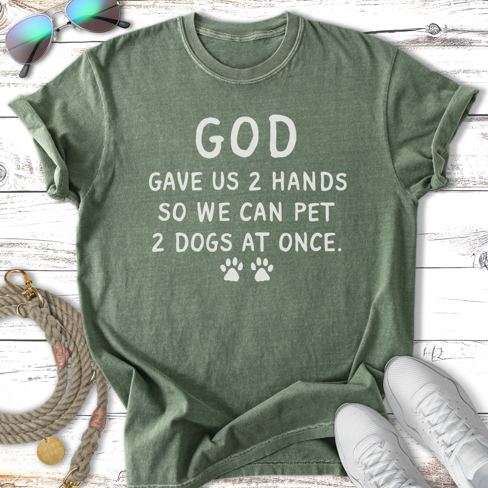 Green t-shirt with "God gave us 2 hands so we can pet 2 dogs at once." text.
