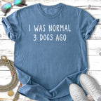 Blue t-shirt with white text "I WAS NORMAL 3 DOGS AGO".
