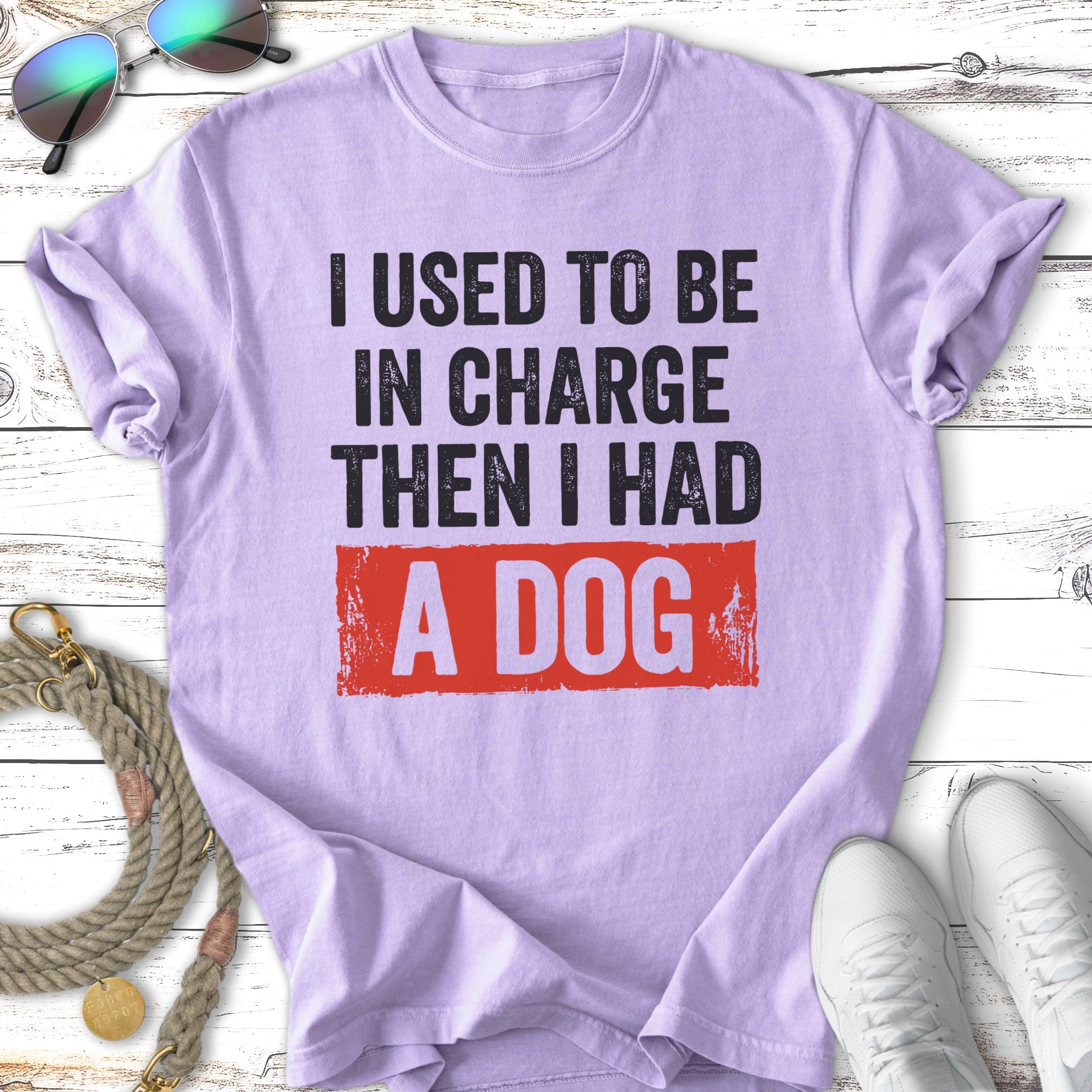 Purple t-shirt with "I used to be in charge then I had a dog" text.