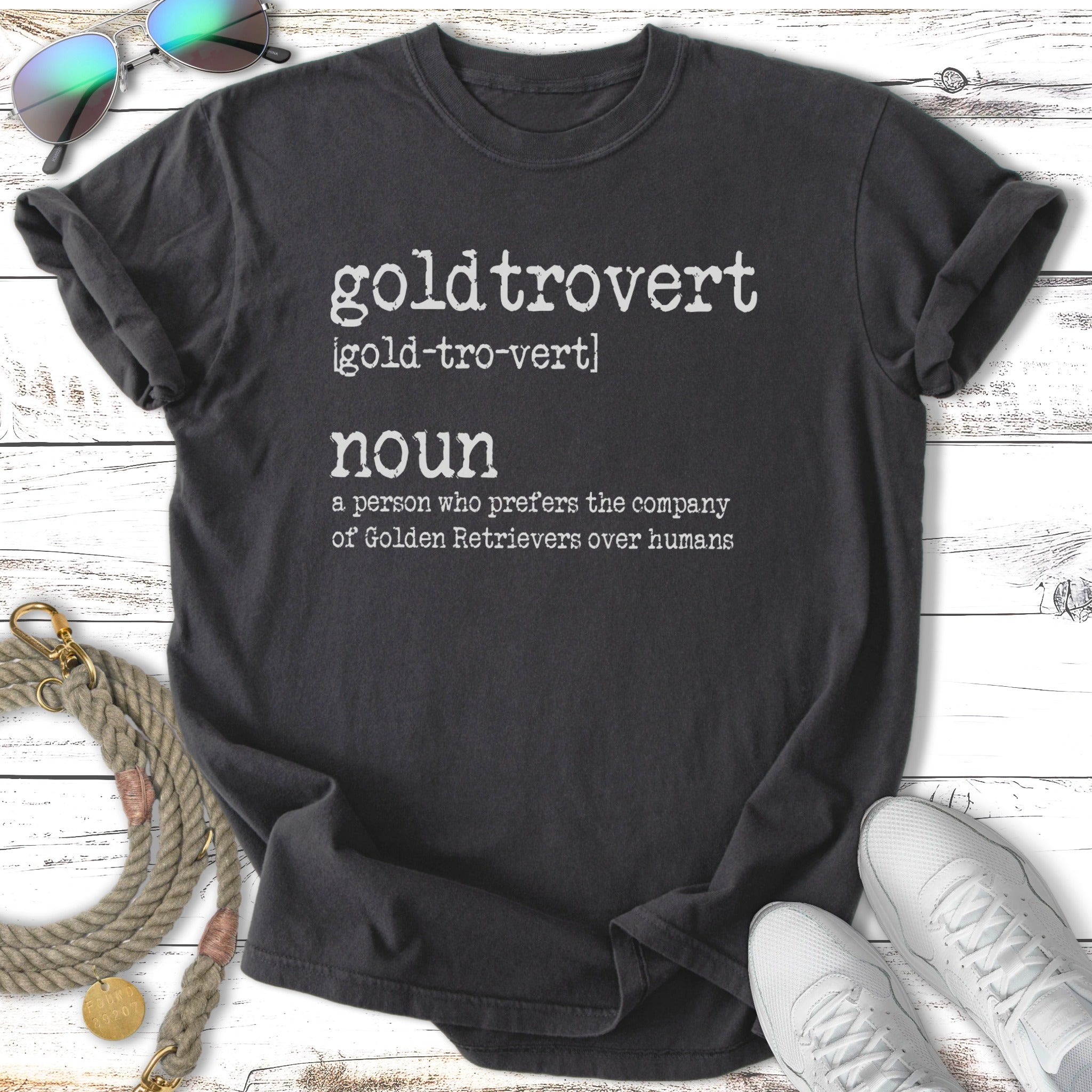 Dark t-shirt with "goldtrovert" definition and Golden Retriever illustration.