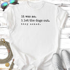White t-shirt with text "it was me. i let the dogs out. they asked."