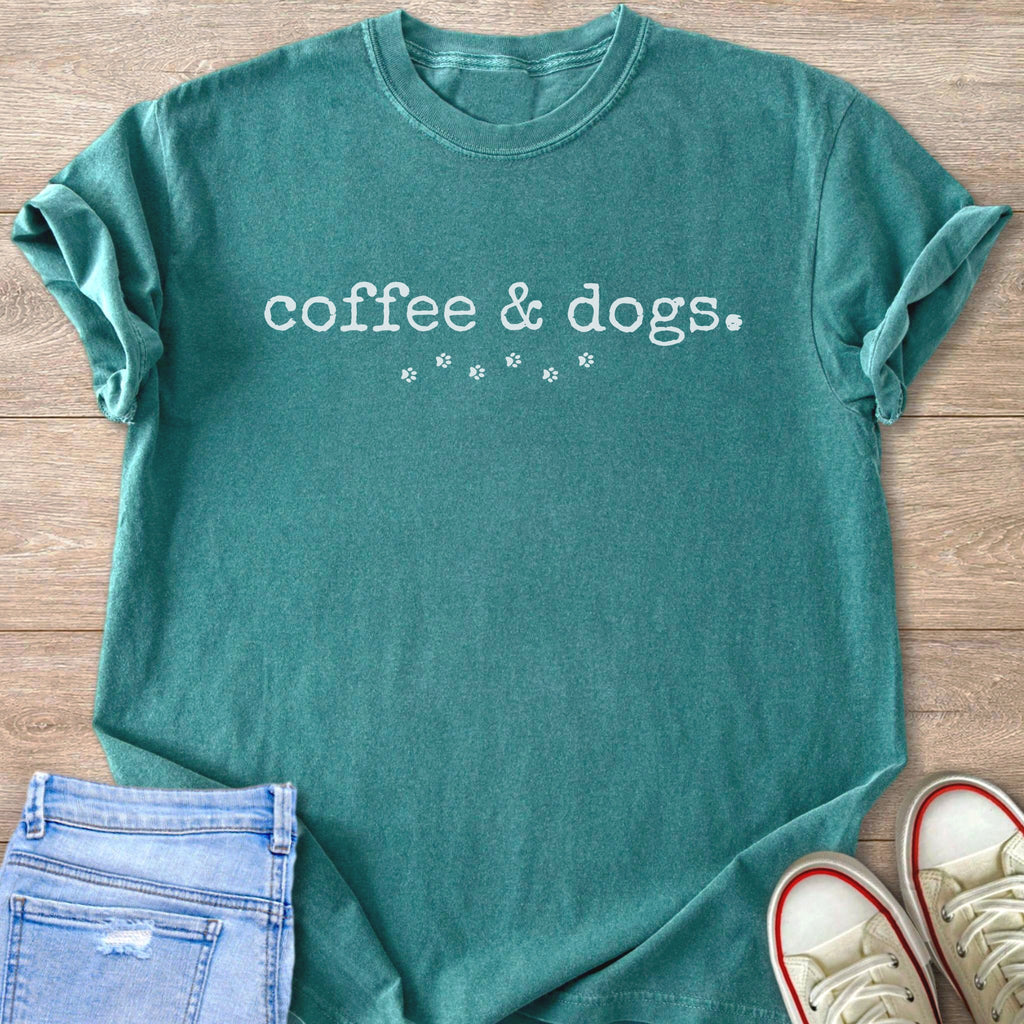 Teal t-shirt with white text "coffee & dogs." and paw prints.
