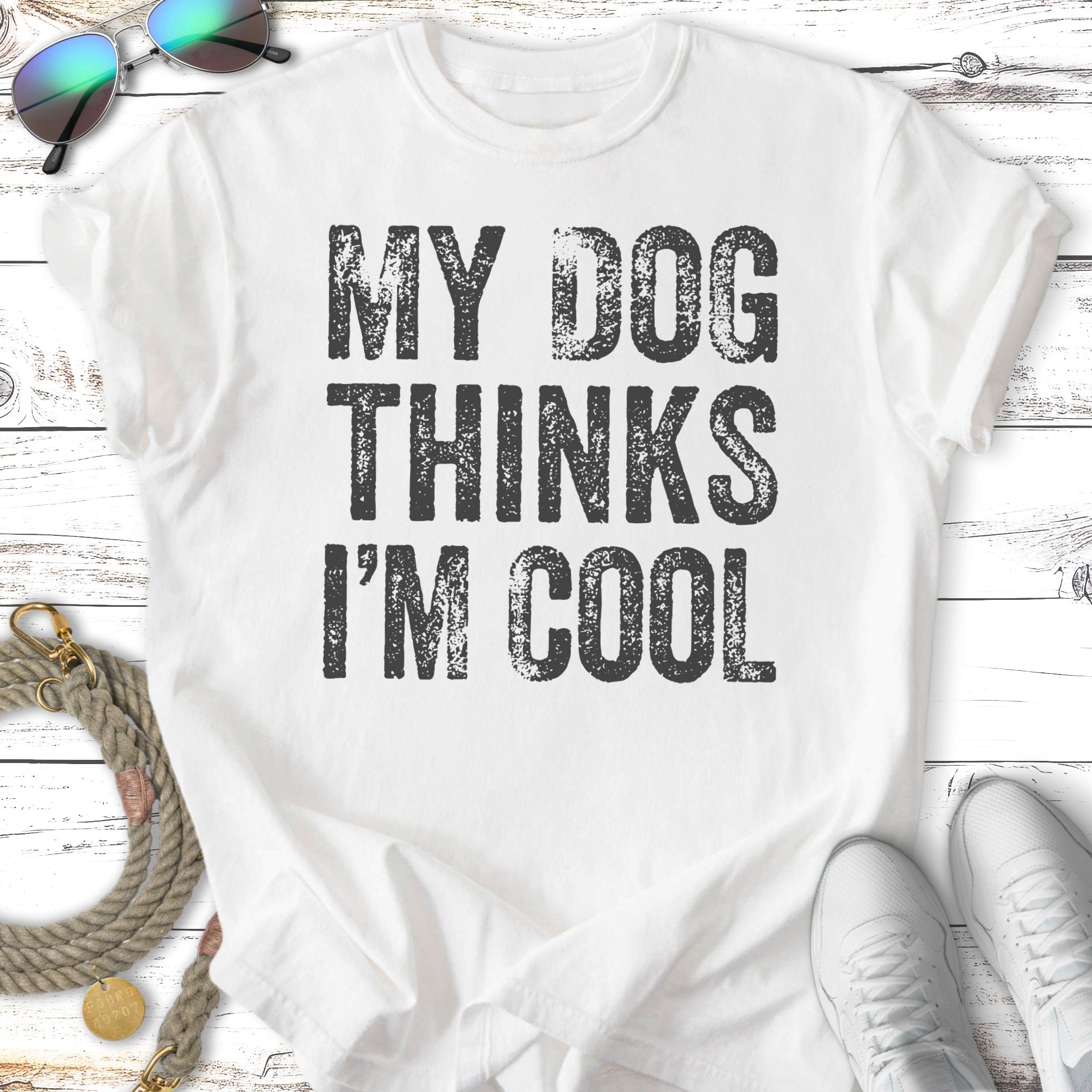 White t-shirt with "MY DOG THINKS I'M COOL" text.
