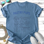 Blue t-shirt with "Pastry Pups" text and illustrations of various pastries with dog silhouettes.