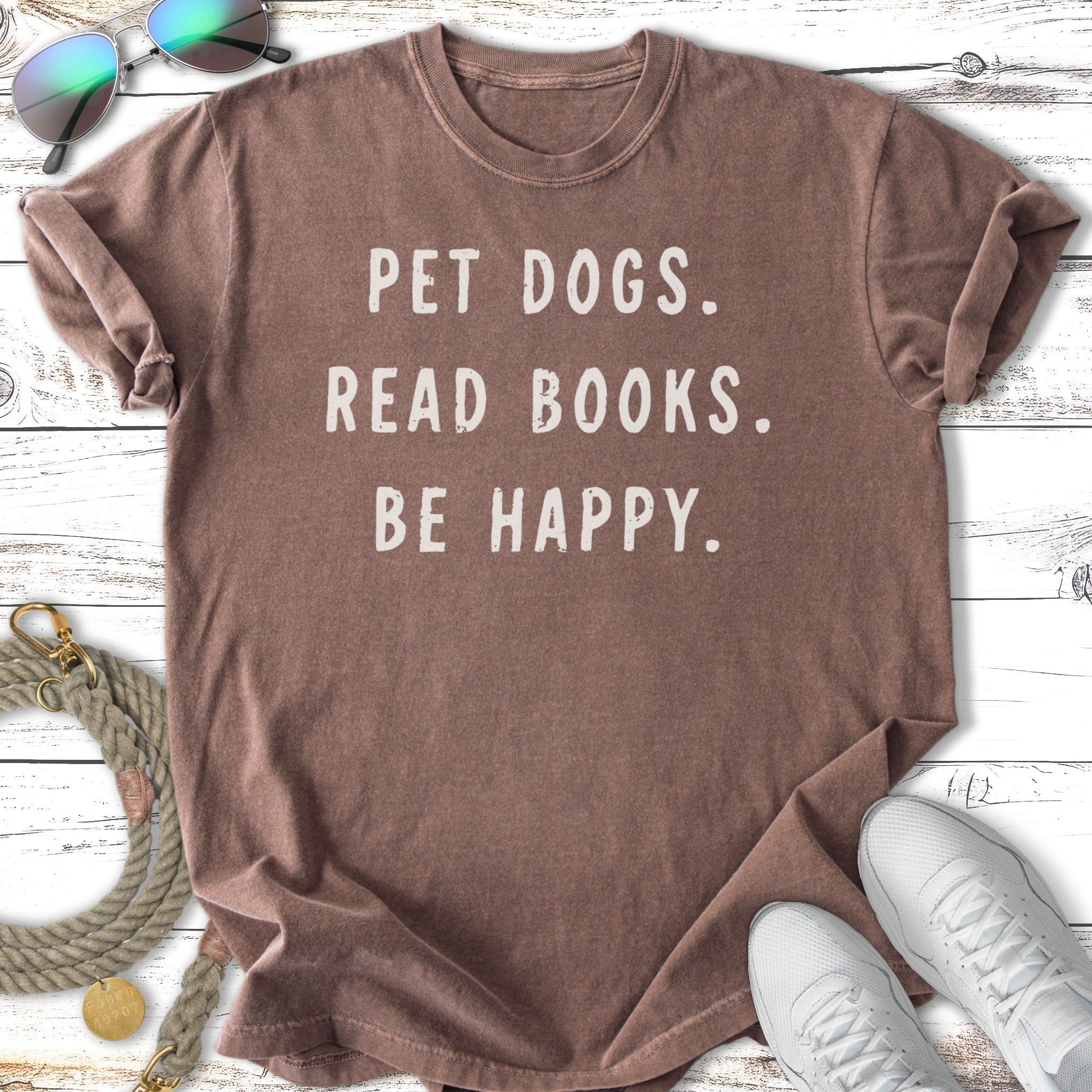 Brown t-shirt with "PET DOGS. READ BOOKS. BE HAPPY." text.