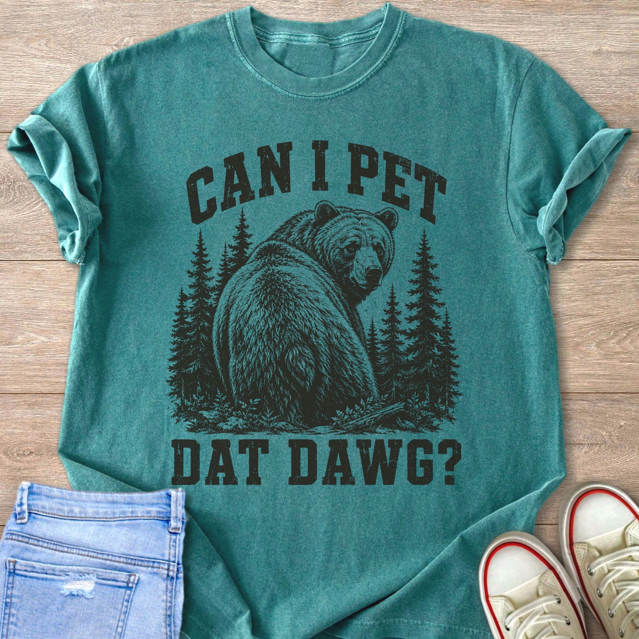 Teal t-shirt with a graphic of a bear in a forest and text "CAN I PET DAT DAWG?"