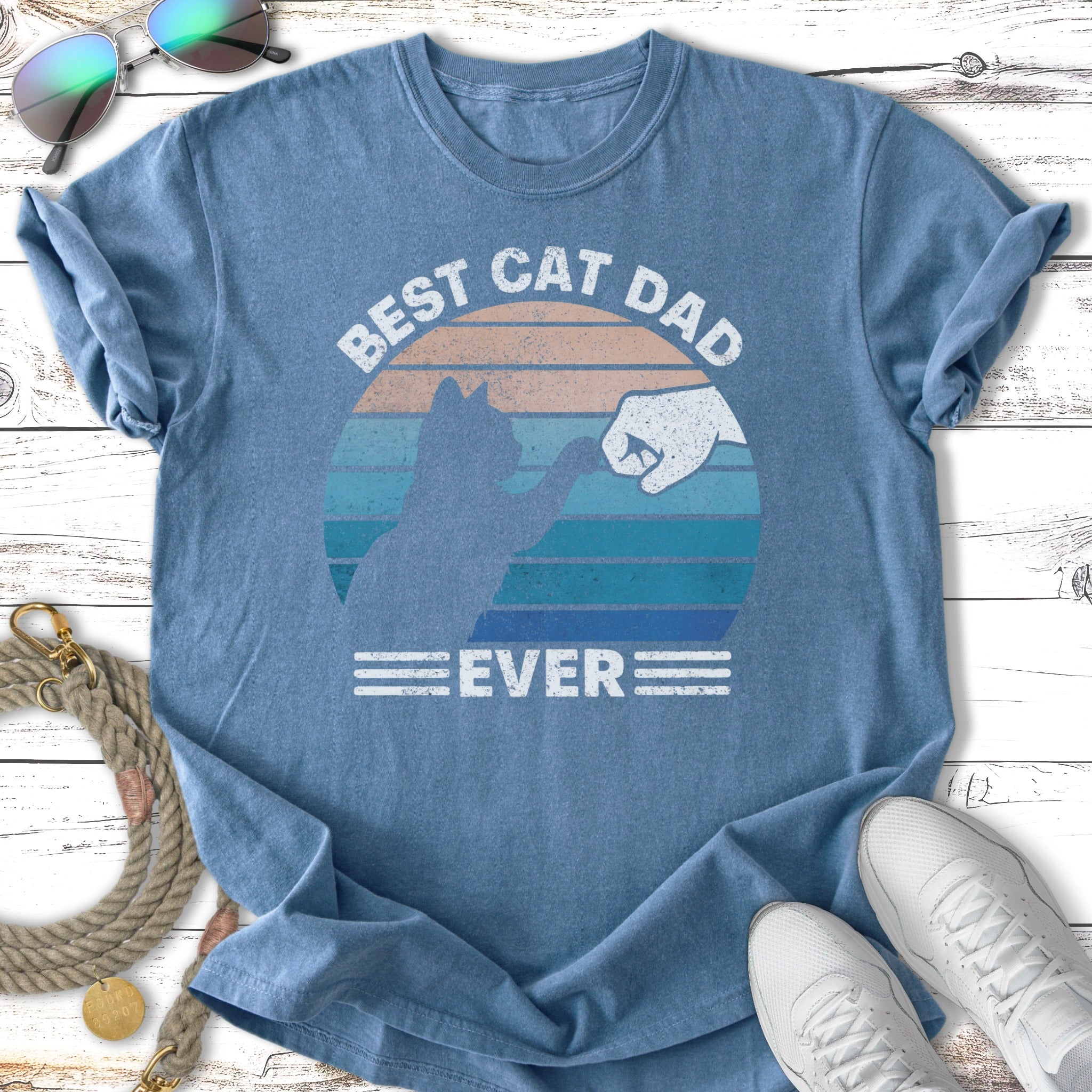 Blue t-shirt with "Best Cat Dad Ever" and a fist bump with a cat silhouette.