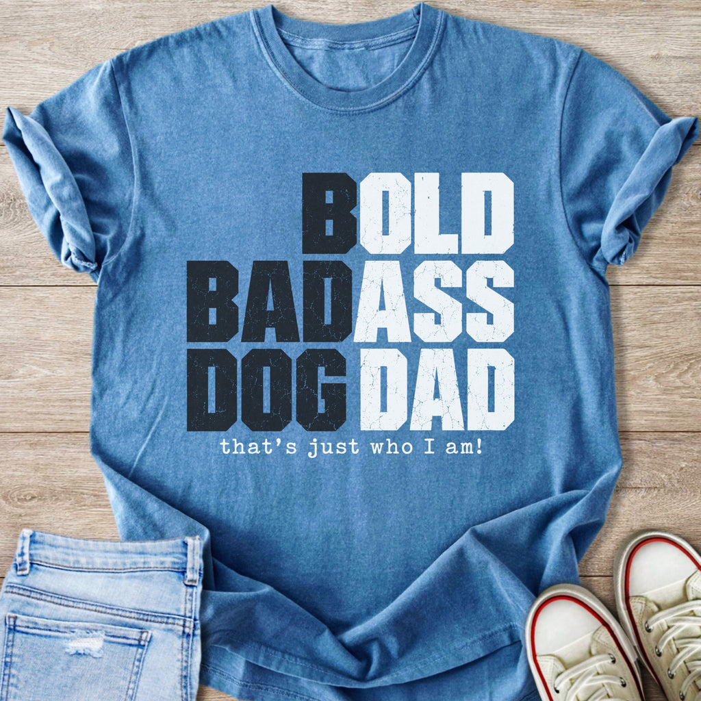 Blue t-shirt with bold graphic text: "BOLD BADASS DOG DAD that's just who I am!"