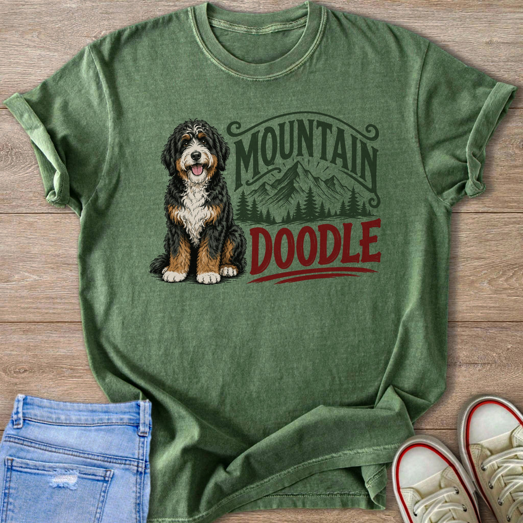 Green t-shirt with a Bernese Mountain Dog doodle and mountain graphic.