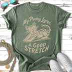 T-shirt with graphic of a cat stretching, text "My Pussy Loves. A Good Stretch."